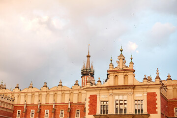 Obraz premium Ancient European architecture. Beautiful facade building on the Market Square in the center of Krakow.