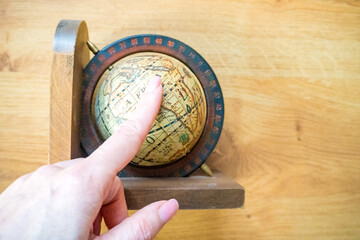 Fototapeta na wymiar Hand catch and Finger point Globe, whole world. Travel, Adventure and Discovery