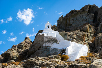 Beautiful Theologaki Chapel on a hill with a  blue sky filled with a white cloud. Naxos Island....