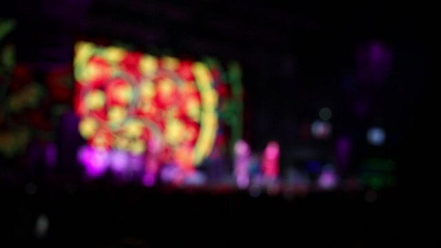 Hands hold phone, that shoots video during show in night club