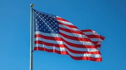 U.S. flag waving against blue sky