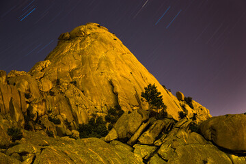 yelmo granitic stone in the pedriza illuminated by light pollution