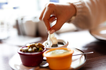 Hand dipping chips in sauces