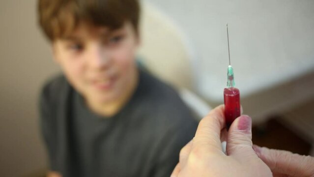 Hands of doctor who releases air from syringe with medicine