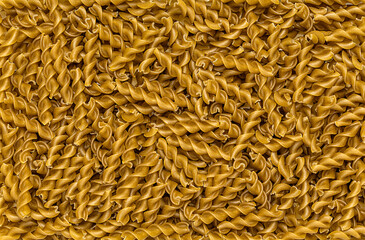 Macro blank photography of green peas fusilli, pasta; macaroni; raw; italian; traditional; vegetarian; natural; carbohydrates; closeup; 