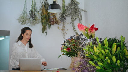 Pensive floristic entrepreneur start work in flower shop office. Business concept.