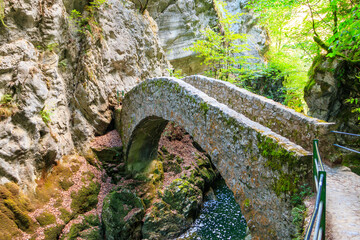 Old small stone bridge over river at Gorges de l'Areuse, Switzerland