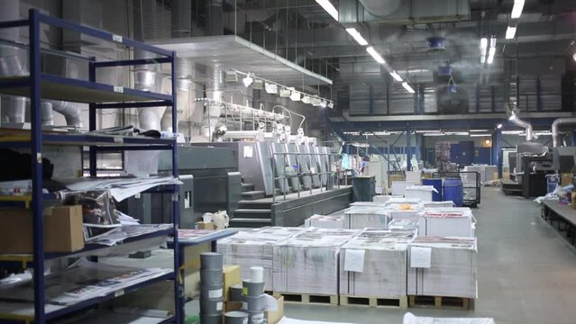 Printing works with printing machines and piles of paper
