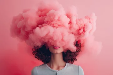 Fotobehang a young woman with her head in pink cloud on a pastel pink background  © Александр Марченко