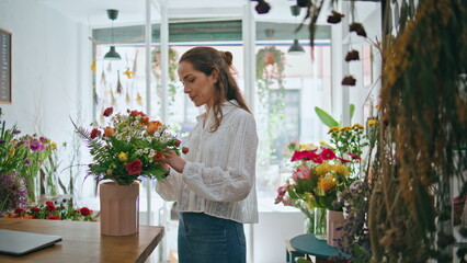 Busy florist make bouquet in flower shop workplace. Small business owner work.