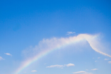 a rainbow appeared in the sky as a result of extinguishing a fire from a fire hydrant with a stream of water