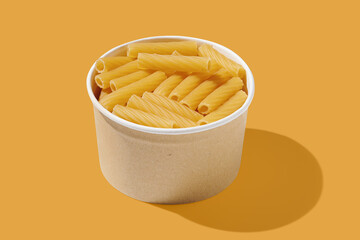 Cannelloni noodle in wooden bowl yellow pastel background