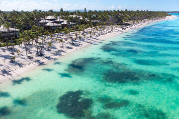 Tropical beach with resorts, palm trees and caribbean sea. Dominican Republic. Aerial view