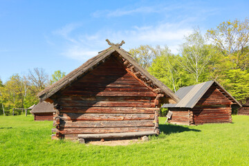 Fototapeta na wymiar Traditional wooden Ukrainian houses from Polissya Region in Pirogovo, Ukraine