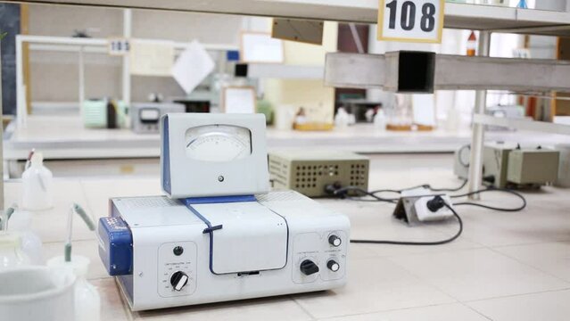 Male hand turns on and configures device for photometric analysis 