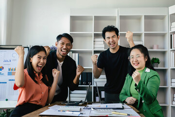 Happy diverse business team celebrating success and having fun all together, Celebration in the office, celebrating a success with raised arms and joyful expressions,