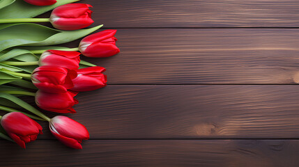 Red tulips on wooden background with copy space.