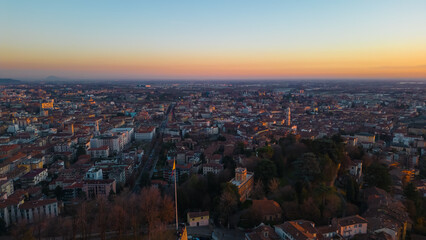 Obraz premium Aerial view Citta Alta Bergamo, Italy. Drone aerial view of the old town during sunrise. Landscape at the city center, its historical buildings. 