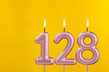 Birthday candle number 128 - Birthday celebration on yellow background