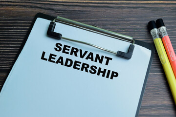 Concept of Servant Leadership write on paperwork isolated on wooden background.