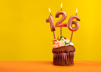 Candle with flame number 126 - Birthday card on yellow background