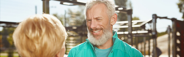 Active morning. Happy senior family couple is doing sport outdoors. Mature bearded man in sport...