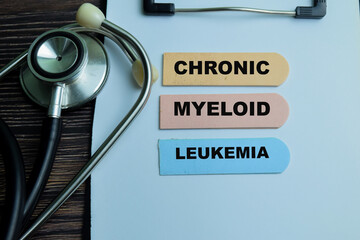Concept of Chronic Myeloid Leukemia write on sticky notes isolated on Wooden Table.