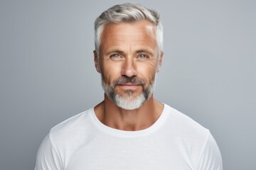 Handsome mature man in white t-shirt. Studio shot