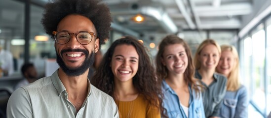 Obraz premium Happy colleagues smiling together in an office, representing diversity and teamwork in the corporate workforce.