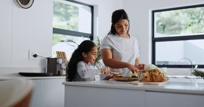 Mother, child and sandwich in kitchen for breakfast, healthy food and cooking lesson at home for bonding. Woman, girl or butter on raisin bread by vegetables, together or care in nutrition on weekend