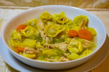 Traditional capeletti soup with chicken and vegetables. Typical winter dinner soup