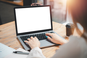 Close-up back view of a business woman working in the office typing, looking at the screen. office...