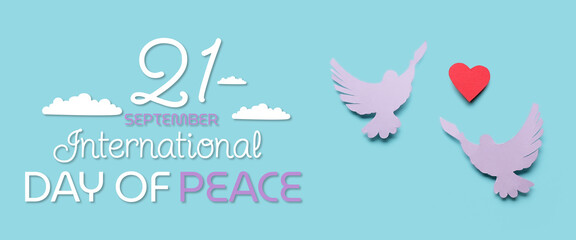 Paper doves and heart on light blue background. Banner for International Day of Peace