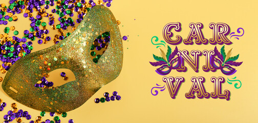 Shiny carnival mask with sequins for Mardi Gras celebration on yellow background