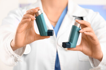 Female doctor with inhalers in office