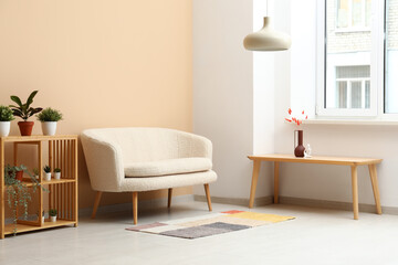 Modern living room interior with cozy white sofa, shelving unit and table