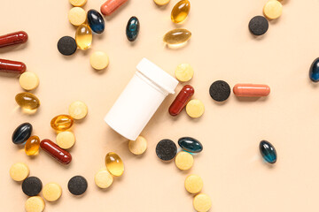 Jar with fish oil capsules and different pills on orange background