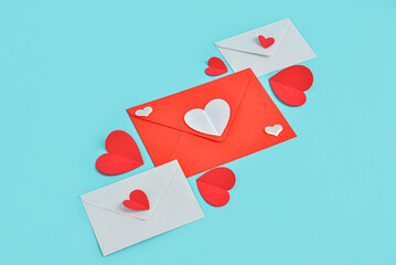 Envelopes with paper hearts on blue background