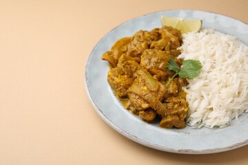 Delicious chicken curry with rice on beige background, closeup. Space for text
