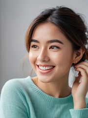 Fototapeta premium Attractive and confident smiling young Asian woman close up portrait