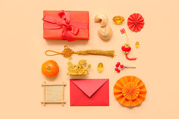 Gift box with envelope, fortune cookies and Chinese symbols on beige background. New Year celebration