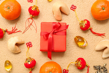 Gift box with mandarins, fortune cookies and Chinese symbols on beige background. New Year celebration