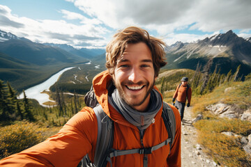 On a hiking trail, a guy takes a selfie with scenic mountain views, showcasing both his outdoor adventure and the breathtaking natural surroundings.