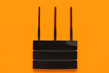 Modern wi-fi router on orange background