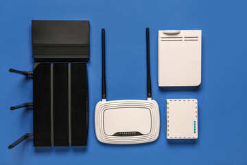 Modern wi-fi routers on blue background