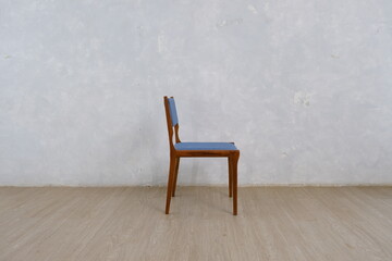 Fototapeta na wymiar teak wood chair in brown color with blue back and seat combination seen from the side