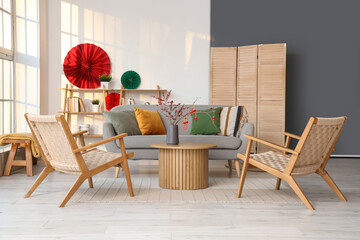 Interior of living room with sofa, armchairs and decor for Chinese New Year celebration