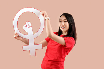 Beautiful young Asian woman with gender symbol on beige background. Women history month