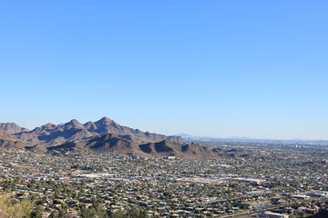 Arizona Valley of the Sun or Greater Phoenix Metro area as seen from North Mountain Park hiking trails toward East on late afternoon, copy space