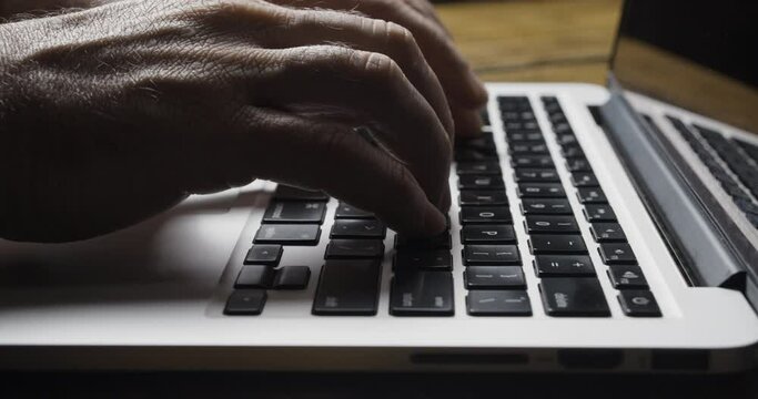 Caucasian Hands Enter Frame and Begin to Type on Silver Laptop Keyboard